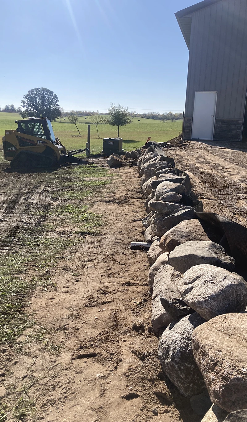 kraemer kontracting installing a driveway and rock wall