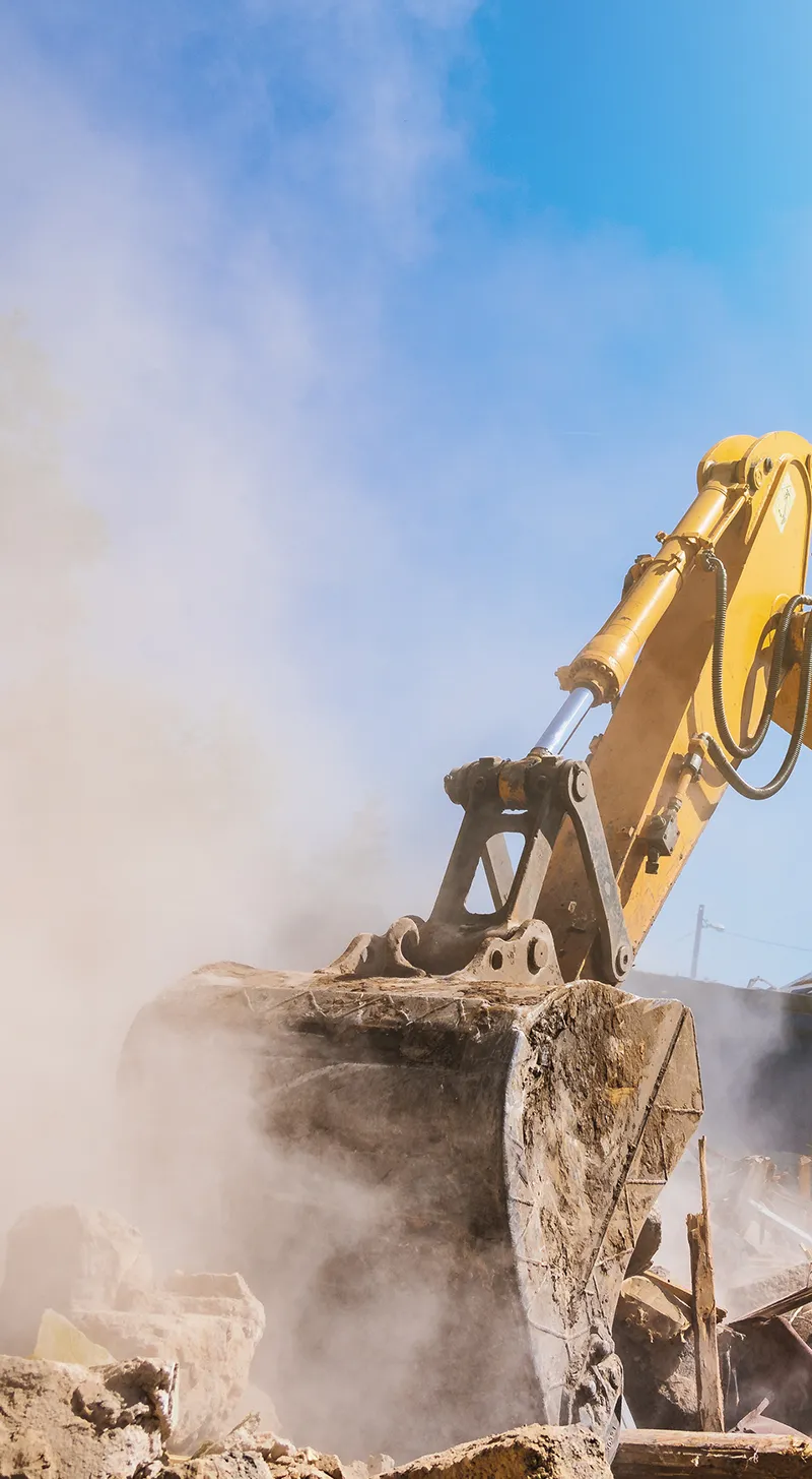 excavator tearing down old building